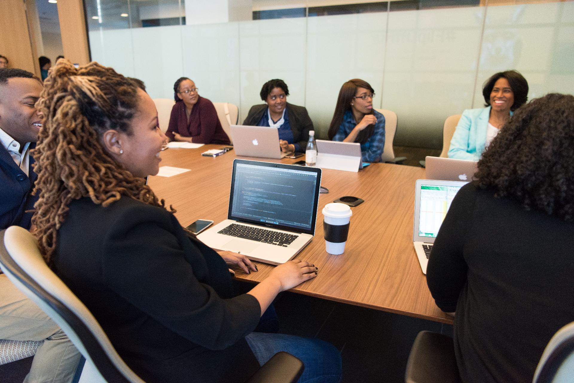 A facilitator leading a corporate wellness workshop with a seated team.